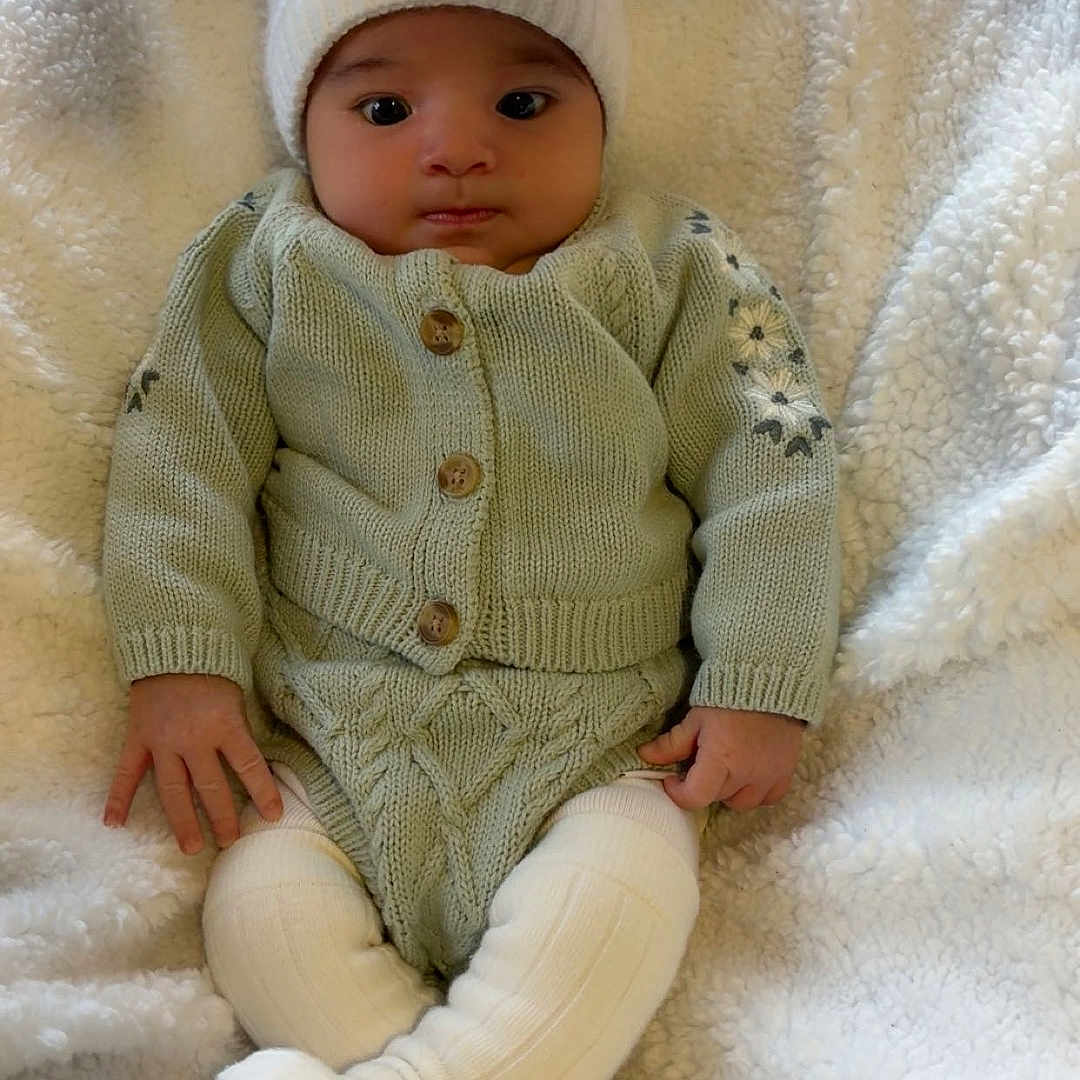 Jesly joined the competition — help win amazing prizes! adorable, baby, baby_fashion, child, comfort, cozy, cute, indoors, infant, knitted_hat, knitted_pants, knitted_sweater, plush, portrait, relaxed, sitting, small_hands, soft_blanket, warm_clothing, white_hat