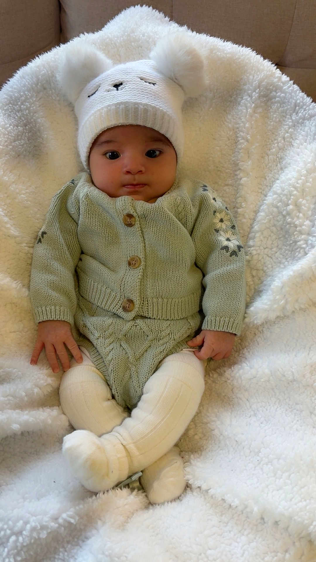 Jesly joined the competition — help win amazing prizes! baby, infant, knitted_hat, white_hat, cozy, soft_blanket, plush, knitted_sweater, knitted_pants, warm_clothing, indoors, cute, child, sitting, small_hands, baby_fashion, comfort, relaxed, portrait, adorable