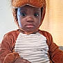 toddler, child, costume, lion, brown, plush, cute, indoor, portrait, face, eyes, hand, sitting, young_child, animal_costume, fabric, expression, person, headgear, soft