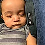 baby, sleeping, car_seat, striped_clothing, infant, child, peaceful, face, closed_eyes, onesie, soft_light, protection_tag, portrait, young_child, resting, cute, head, arm, closeup, indoors
