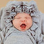 Olenna is registered to the contest to win money with this photo: baby, infant, yawning, face, headwear, bonnet, clothing, fabric, soft, sleepy, cute, closeup, portrait, newborn, child, person, apparel, texture, neutral_background, indoors