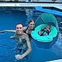 man, woman, baby, pool, water, swimming, float, baby_float, sunshade, smile, outdoor, summer, family, relaxation, can, swimwear, tattoo, blue, backyard, happy
