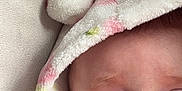 Lottie joined the competition — help win amazing prizes! baby, child, face, hood, blanket, blue_eyes, expression, cute, soft_texture, warm_clothing, indoor, infant, close_up, skin, person, newborn, apparel, headwear, surprised, young