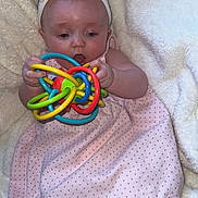 Lottie joined the competition — help win amazing prizes! baby, child, headband, bow, toy, colorful, pink_dress, polka_dot, blanket, fluffy, infant, cute, playing, hands, legs, expression, indoors, soft_texture, focus, person