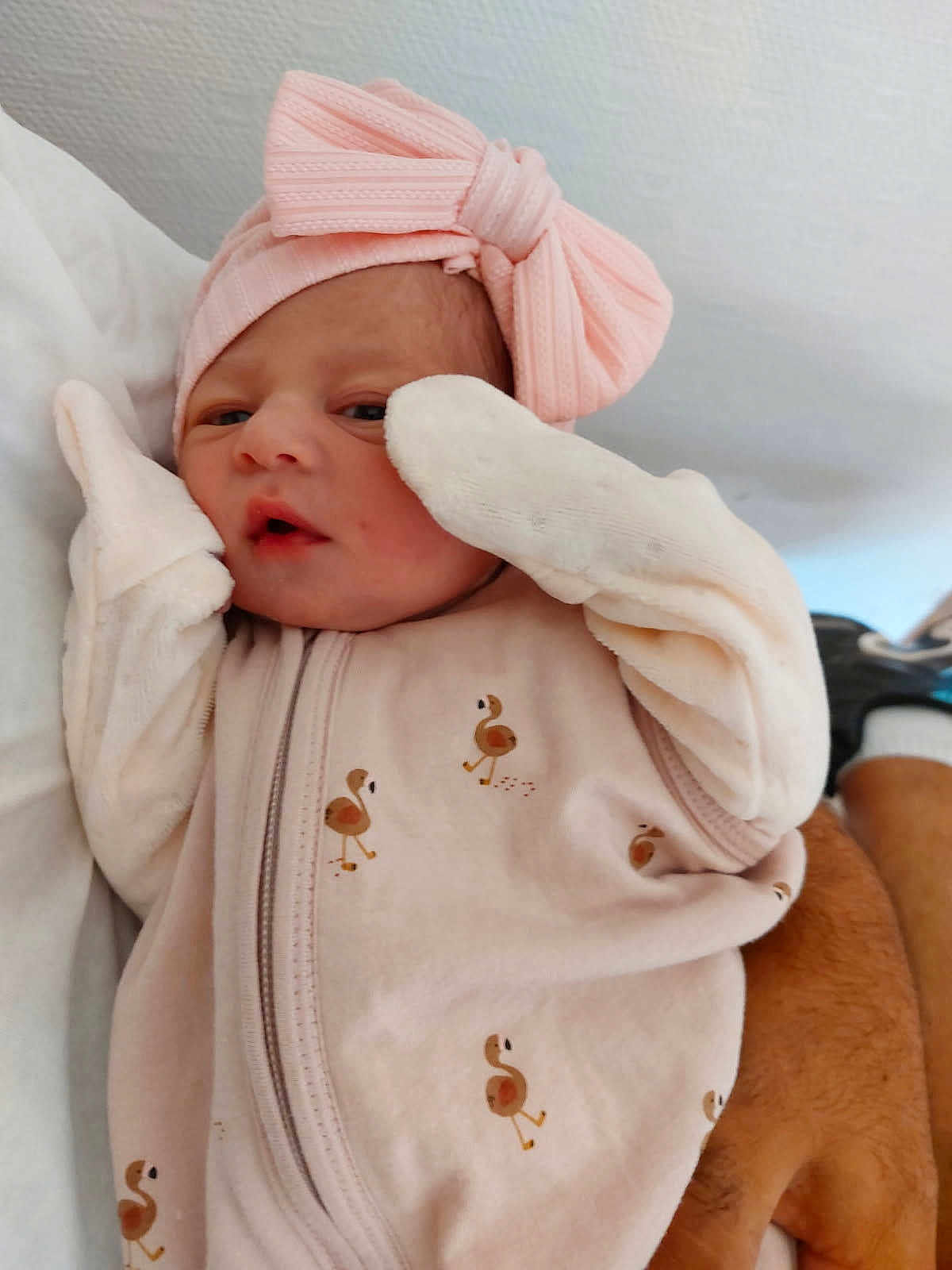 Cassie participe au concours pour gagner de l'argent avec cette photo : baby, newborn, pink, bow, mittens, flamingo_pattern, sleepwear, infant, cute, soft, hand, resting, portrait, clothing, headband, person, skin, face, lying_down, cozy