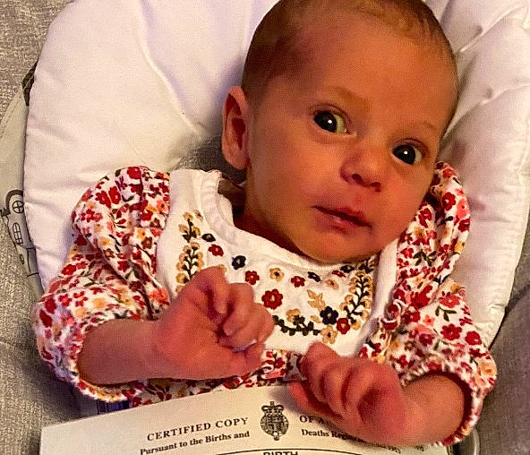 Khaleesi is registered to the contest to win money with this photo: baby, baby_toddler_clothing, cheek, chin, collar, comfort, eye, eyelash, face, gesture, happy, head, linens, lip, nail, nose, person, skin, sleeve, textile