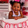 Khilani is registered to the contest to win money with this photo: baby, birthday, celebration, child, cute, decorations, festive, fun, girl, hair_bows, happy, infant, one_year_old, party, pink, pink_background, portrait, smiling, strawberries, white_box