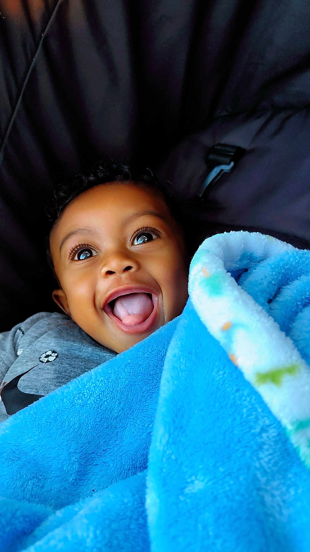 Kario joined the competition — help win amazing prizes! child, toddler, smiling, happy, blanket, blue_blanket, face, curly_hair, clothing, gray_shirt, closeup, portrait, indoors, cute, baby, person, joy, excitement, warm, soft_texture