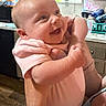baby, infant, smile, happy, person, kitchen, window, cabinet, onesie, arm, hand, indoor, home, human, face, skin, holding, expression, child, cute