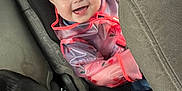 Emma'Mae joined the competition — help win amazing prizes! toddler, child, car_seat, raincoat, smiling, happy, dog, black_dog, car_interior, seatbelt, jacket, transparent_clothing, vehicle, pet, canine, young_child, baby, portrait, indoor, cute