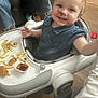 Emma'Mae joined the competition — help win amazing prizes! toddler, baby_walker, food, fries, chicken_nuggets, sauce, messy, smiling, face, hands, clothing, wooden_floor, adult, jeans, high_chair, indoor, meal, happy, cute, child