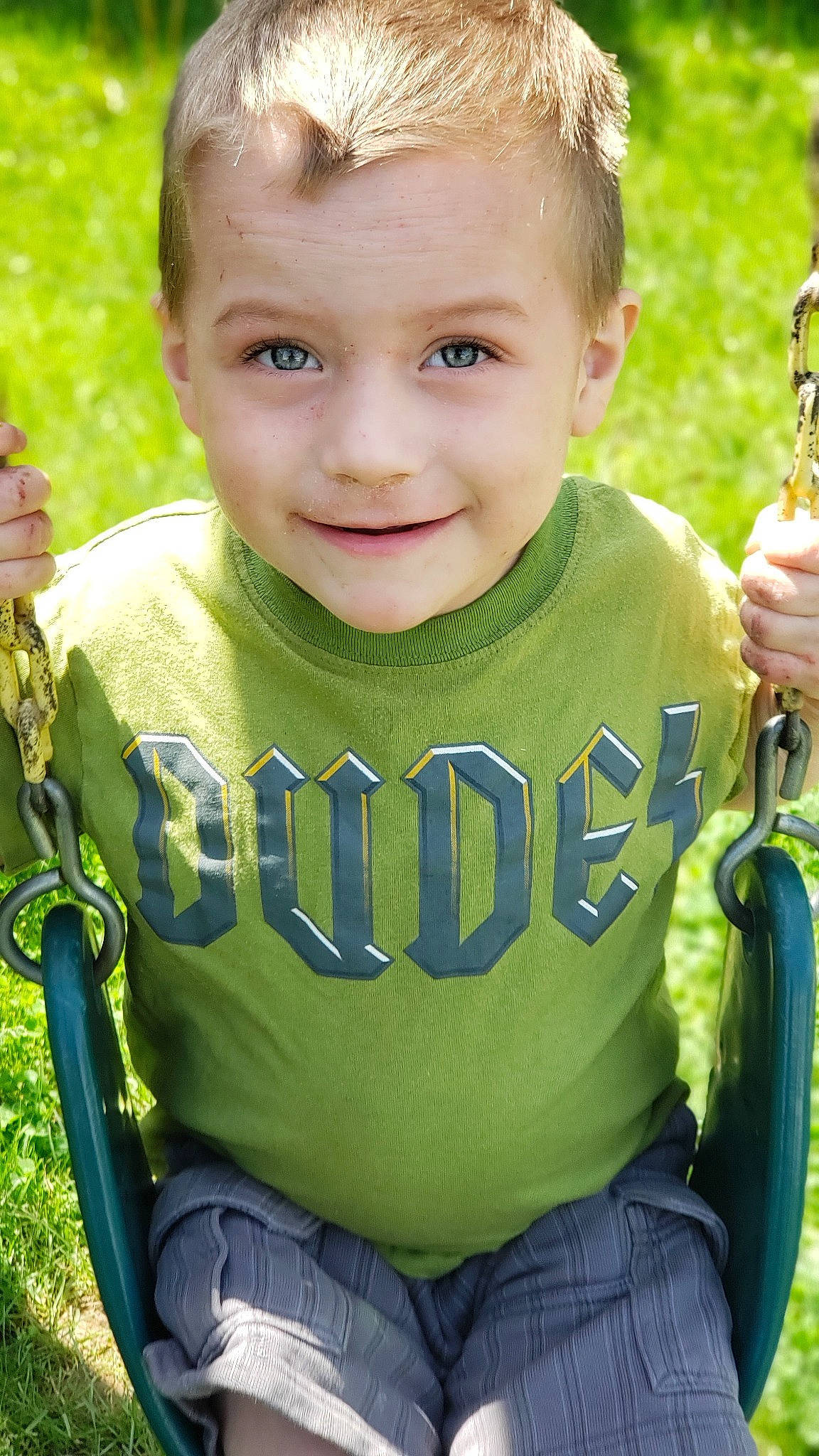 Jace is registered to the contest to win money with this photo: child, cool, grass, green, happy, joy, outdoor_play_equipment, person, plant, play, smile, swing, t_shirt, toddler