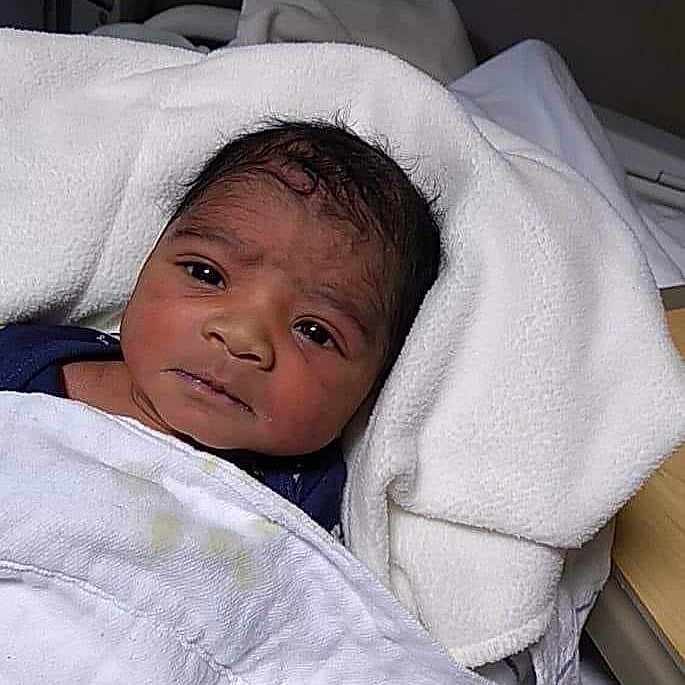 Jamarcus is registered to the contest to win money with this photo: baby, bed, blanket, child, clothing, cute, face, healthcare, hospital, indoors, infant, newborn, newborn_bassinet, person, resting, sleeping, soft, towel, wrapped, young