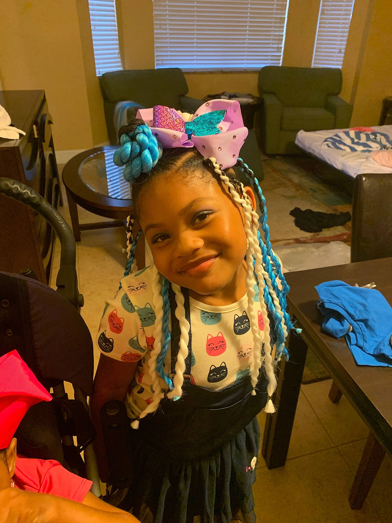 Damiyah is registered to the contest to win money with this photo: backpack, box, chair, child, costume, curtain, event, fashion_accessory, fashion_design, fun, hair_accessory, happy, joy, luggage_and_bags, person, room, smile, table, toddler, visual_arts