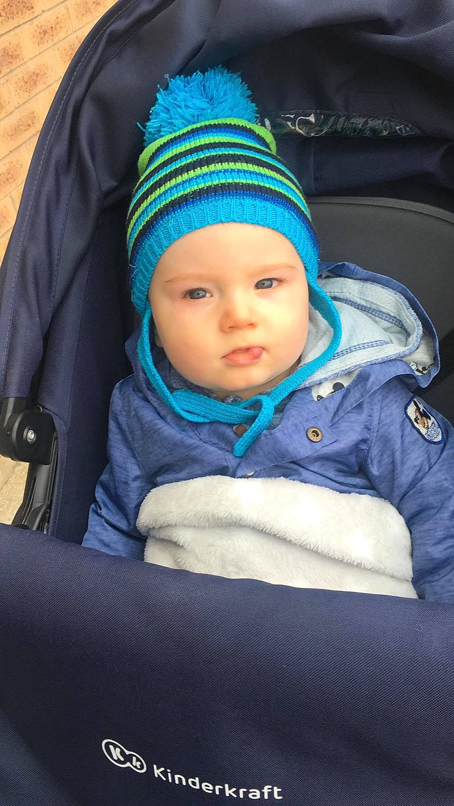 Marco is registered to the contest to win money with this photo: azure, baby, cap, cheek, child, comfort, cool, electric_blue, eye, face, flash_photography, fun, headgear, headwear, jacket, knit_cap, outerwear, person, purple, sitting