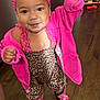 toddler, child, indoor, pink_jacket, leopard_print, headband, pacifier, smiling, happy, floor, shoes, person, clothing, cute, baby, small_child, standing, hand_raised, wooden_floor, footwear
