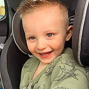Jake is registered to the contest to win money with this photo: accessories, baby, belt, bodypart, clothing, coat, cushion, dress, face, formalwear, happy, head, headrest, homedecor, mouth, person, photography, portrait, smile, teeth