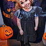 Ruthie Kay is registered to the contest to win money with this photo: background, black, boots, child, costume, decorations, dress, face_paint, girl, halloween, happy, holiday, indoor, jack_o_lantern, orange, party, portrait, pumpkin, smile, spooky