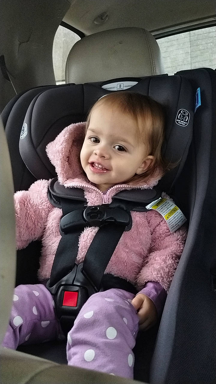 Sadie is registered to the contest to win money with this photo: auto_part, baby, baby_carriage, baby_products, baby_safety, baby_toddler_clothing, beauty, car, car_seat, car_seat_cover, child, comfort, family_car, head_restraint, joy, luxury_vehicle, person, seat_belt, sitting, smile