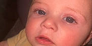 Luca is registered to the contest to win money with this photo: baby, child, face, blue_eyes, skin, yellow_shirt, closeup, infant, portrait, cute, expression, young, person, human, eyelashes, head, soft_light, indoors, sleeve, clothing