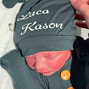Luca is registered to the contest to win money with this photo: newborn, baby, sleeping, hat, clothing, buttons, hand, blanket, pattern, zebra, infant, cute, resting, soft, fabric, bedtime, closeup, portrait, child, peaceful