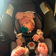 Naomi joined the competition — help win amazing prizes! baby, infant, car_seat, pacifier, headband, pink_bow, feet, hands, clothing, safety_belt, child, cute, indoors, person, seat, infant_clothing, baby_girl, closeup, newborn, adorable