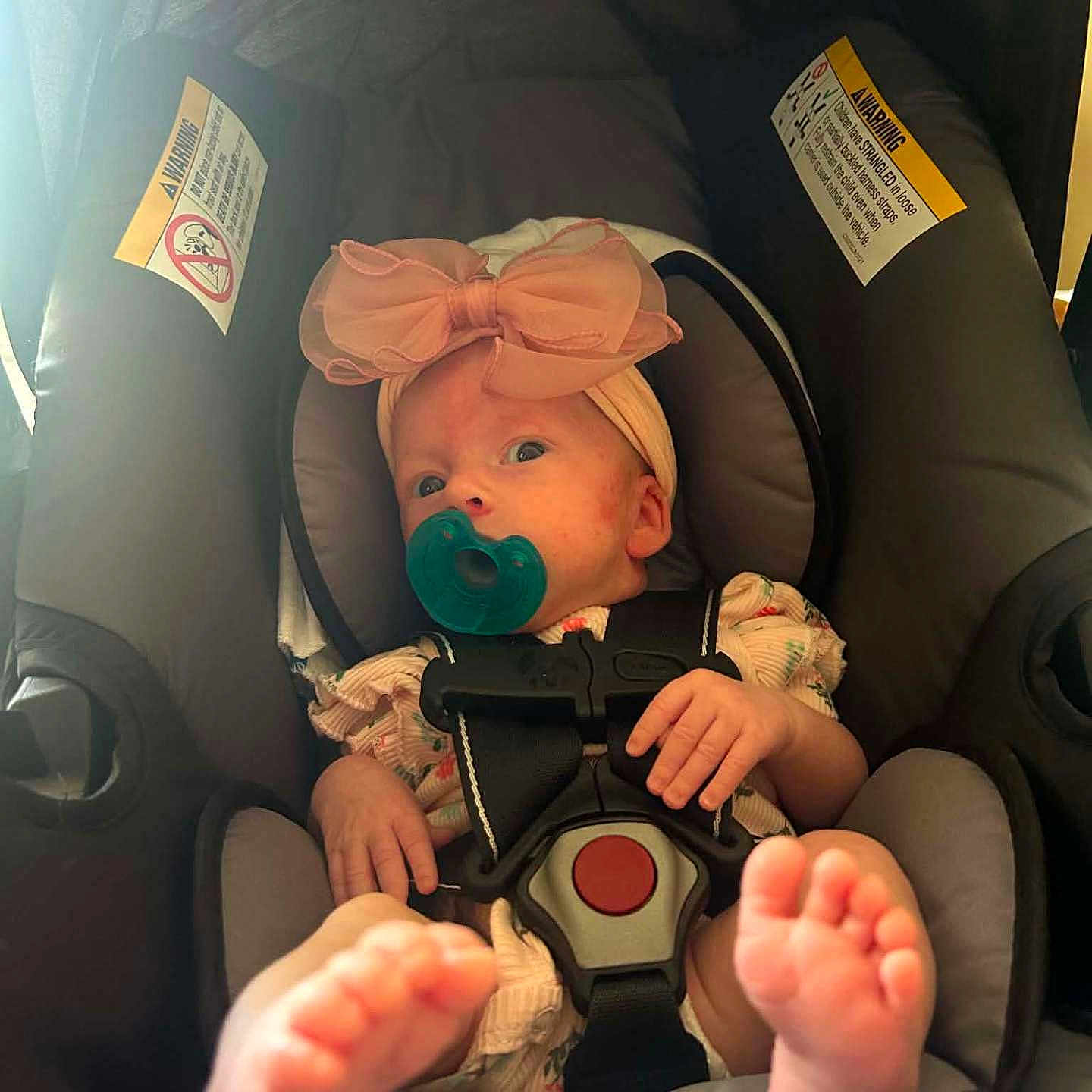 Naomi joined the competition — help win amazing prizes! baby, infant, car_seat, pacifier, headband, pink_bow, feet, hands, clothing, safety_belt, child, cute, indoors, person, seat, infant_clothing, baby_girl, closeup, newborn, adorable