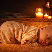 Berkeley joined the competition — help win amazing prizes! baby, sleeping, pajamas, blanket, face, infant, cozy, candles, warm_light, bedtime, peaceful, cute, soft_texture, indoors, rest, newborn, comfort, portrait, relaxation, child