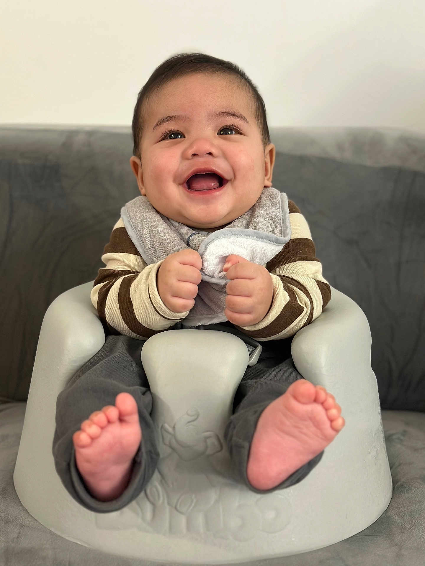 Kent Michael joined the competition — help win amazing prizes! baby, smiling, infant, baby_seat, bib, striped_sweater, happy, cute, hands, feet, indoor, portrait, child, seated, rosy_cheeks, young_child, clothing, face, person, comfort