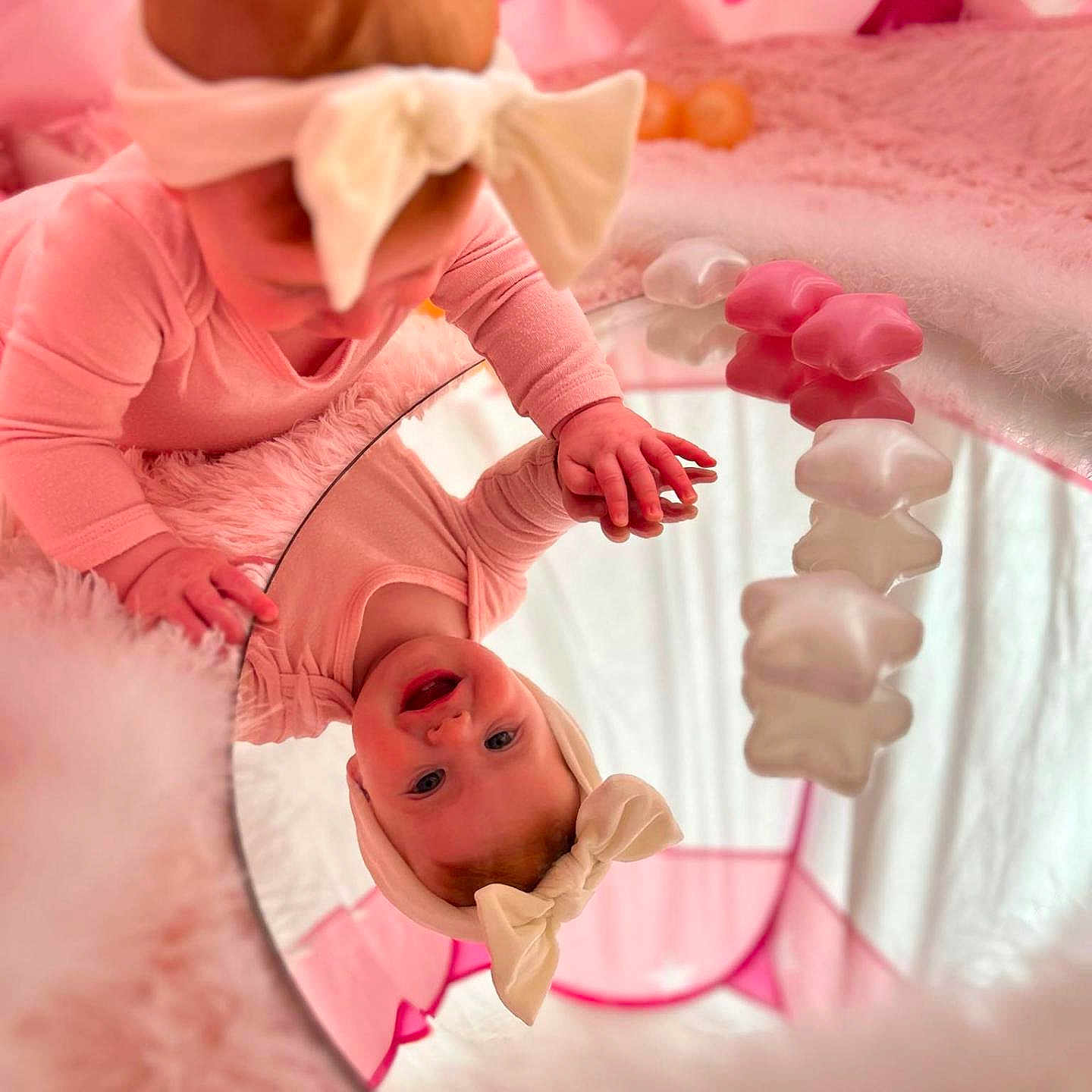 Bella joined the competition — help win amazing prizes! baby, bed, clothing, crib, face, flower, furniture, glove, happy, hat, head, indoors, infantbed, newborn, people, person, petal, photography, plant, portrait
