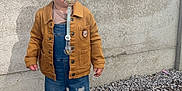 Sacha participe au concours pour gagner de l'argent avec cette photo : casual, child, clothing, concrete_wall, denim_overalls, fashion, footwear, ground, jacket, outdoor, pacifier, pebbles, person, serious_expression, standing, texture, toddler, wear, white_sneakers, young_child