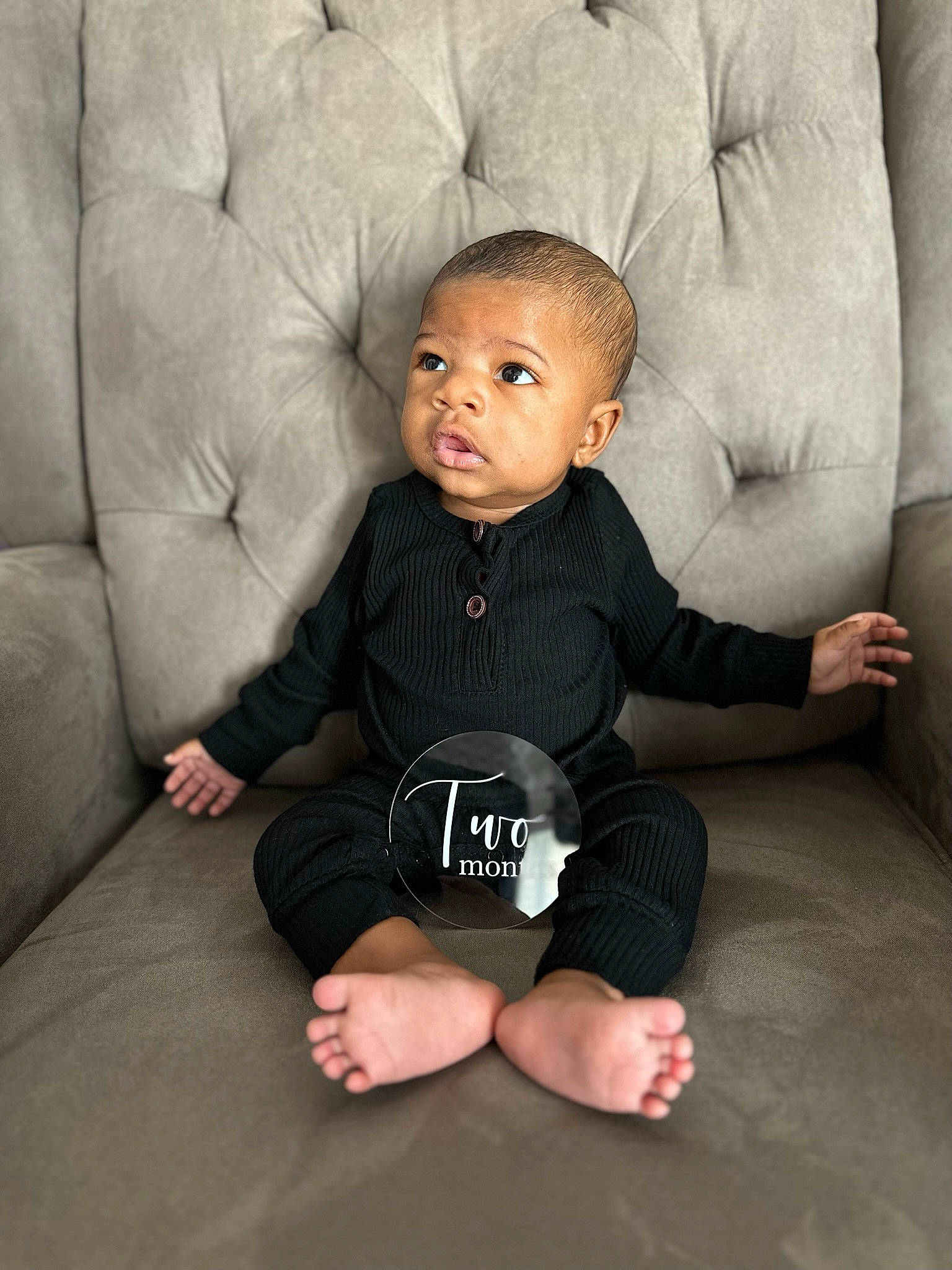 Marcus Jr. is registered to the contest to win money with this photo: baby, baby_toddler_clothing, cheek, chin, comfort, eye, face, flash_photography, floor, flooring, grey, happy, human_body, mouth, neck, nose, person, skin, sleeve, toddler