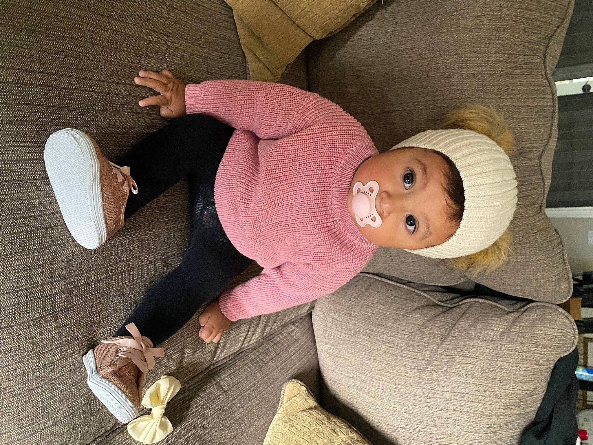 Addilyn is registered to the contest to win money with this photo: baby, beanie, cap, car_seat, child, comfort, fashion_accessory, finger, flooring, foot, hat, human_leg, knee, lap, person, sitting, smile, thigh, thumb, toddler