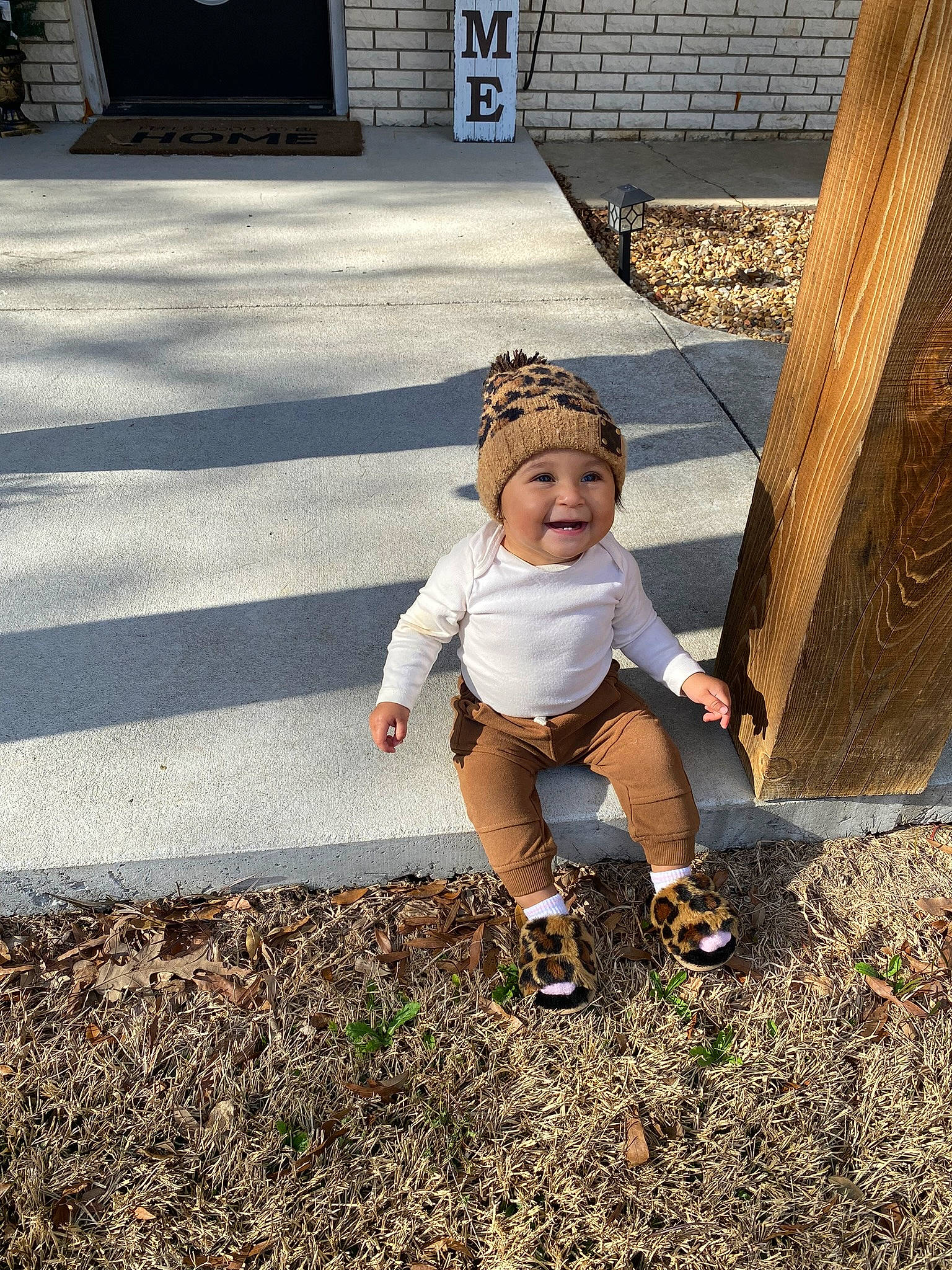 Addilyn joined the competition — help win amazing prizes! asphalt, cap, child, fun, grass, happy, hat, headwear, human_leg, joy, landscape, leisure, people_in_nature, person, road_surface, shadow, sidewalk, sitting, sneakers, soil