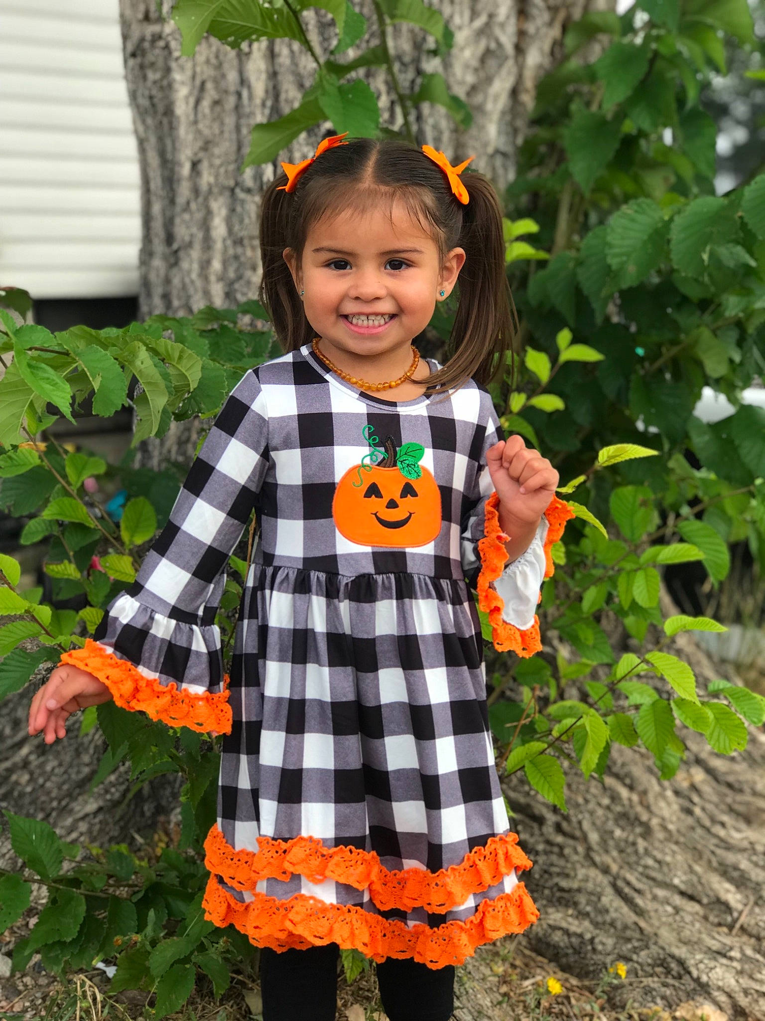Daya is registered to the contest to win money with this photo: baby_toddler_clothing, child, child_model, clothing, costume, design, joy, orange, pattern, person, plaid, plant, pumpkin, sleeve, tartan, textile, toddler