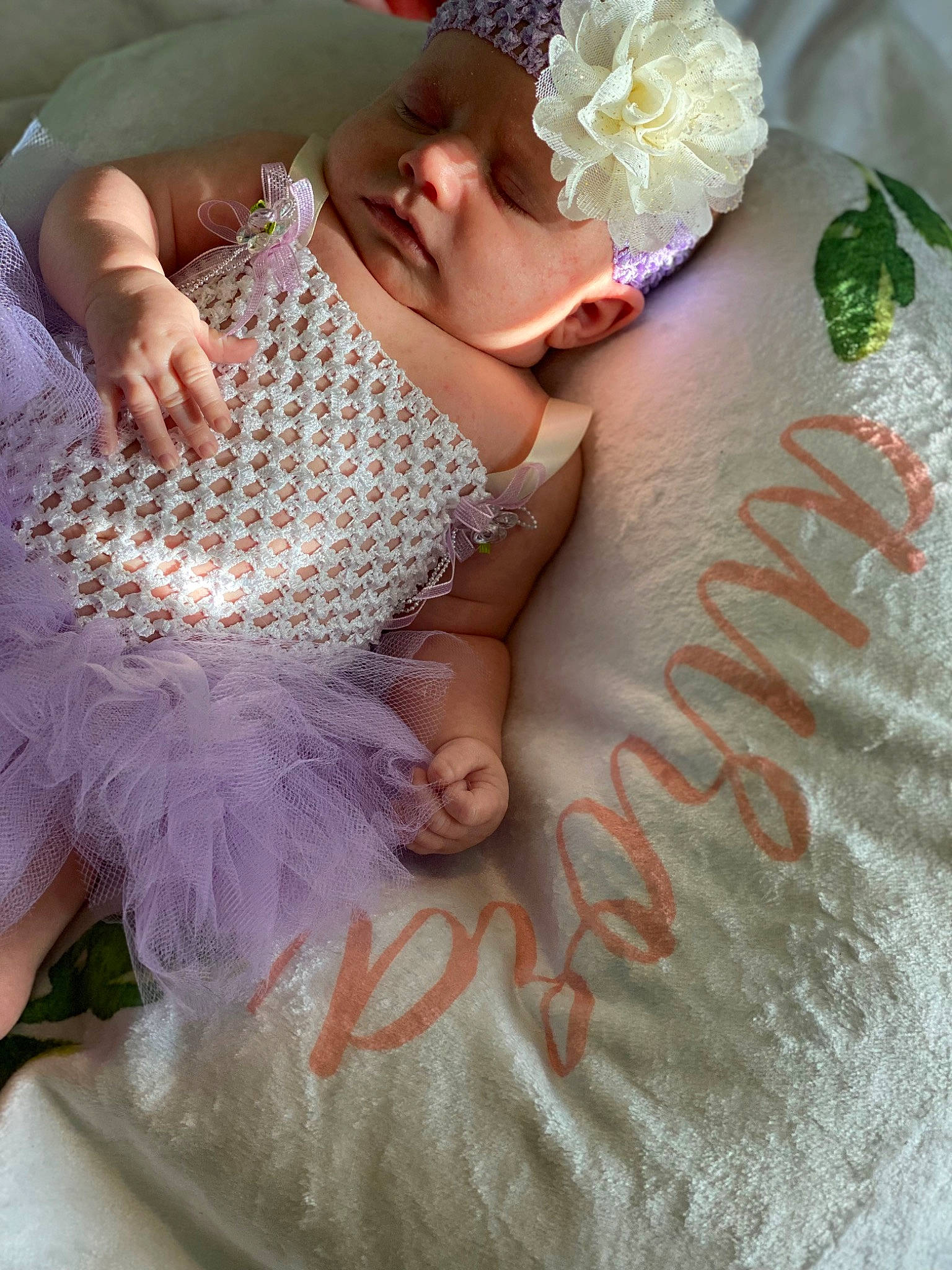 Aurora is registered to the contest to win money with this photo: baby, baby_toddler_clothing, child, dress, embellishment, finger, flower, grass, hand, happy, hat, headpiece, headwear, nail, person, petal, pink, plant, skin, textile