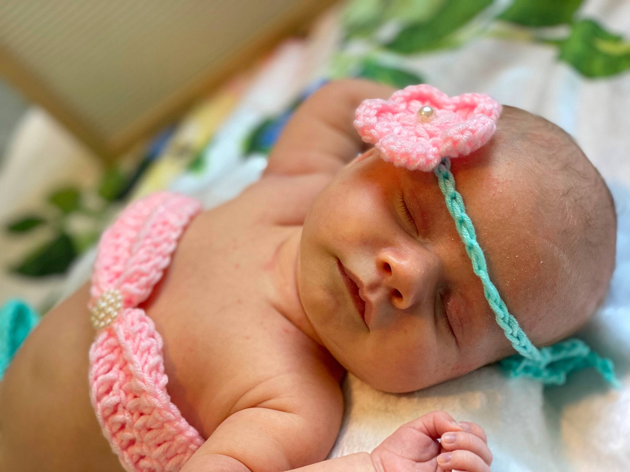 Aurora is registered to the contest to win money with this photo: baby, baby_sleeping, baby_toddler_clothing, cheek, comfort, eyelash, finger, grass, hand, happy, head, headband, headgear, headpiece, mouth, nose, person, pink, plant, skin