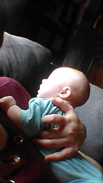 Danny is registered to the contest to win money with this photo: abdomen, arm, baby, baby_toddler_clothing, cheek, child, comfort, darkness, ear, elbow, finger, flash_photography, fun, gesture, hand, nail, person, sitting, thumb, toddler