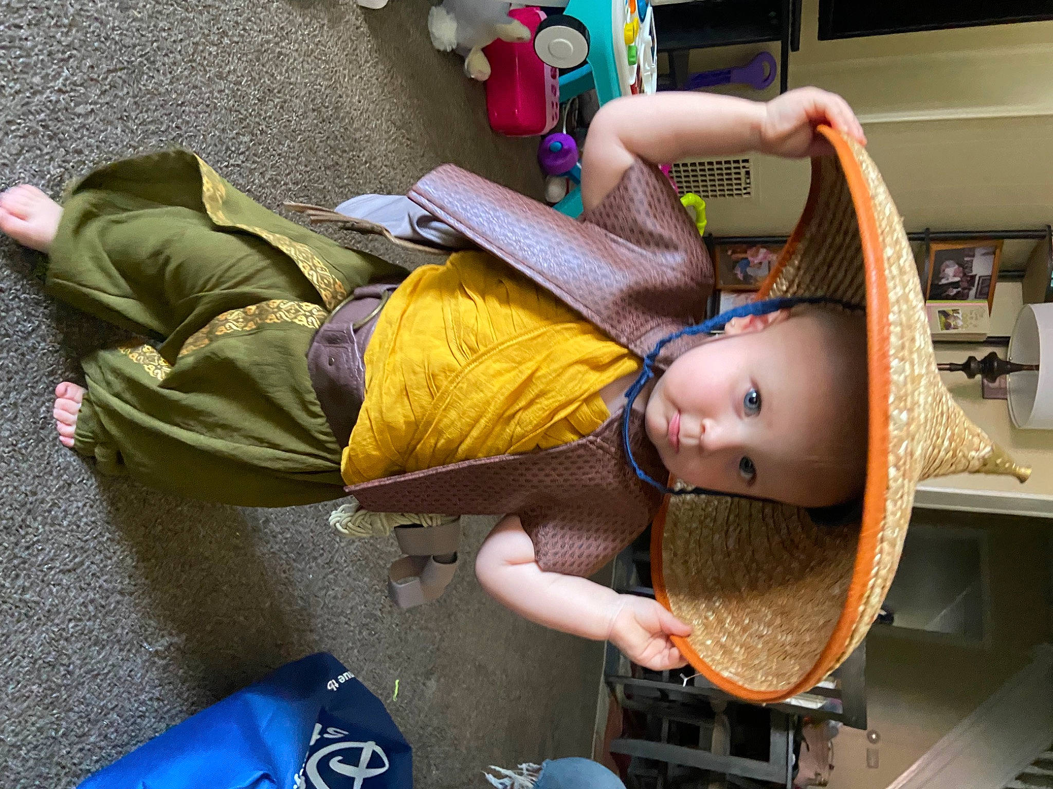 Emmie is registered to the contest to win money with this photo: baby, baby_products, bag, child, comfort, doll, fashion_accessory, fun, hat, headwear, human_leg, leisure, person, room, shelf, shelving, sitting, stuffed_toy, thigh, toddler