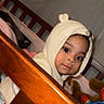 Hazel joined the competition — help win amazing prizes! toddler, child, crib, wooden_rail, knit_hoodie, ears, stuffed_toys, indoor, curious, face, baby, cute, soft_lighting, portrait, clothing, toy, playtime, infant, person, young_child