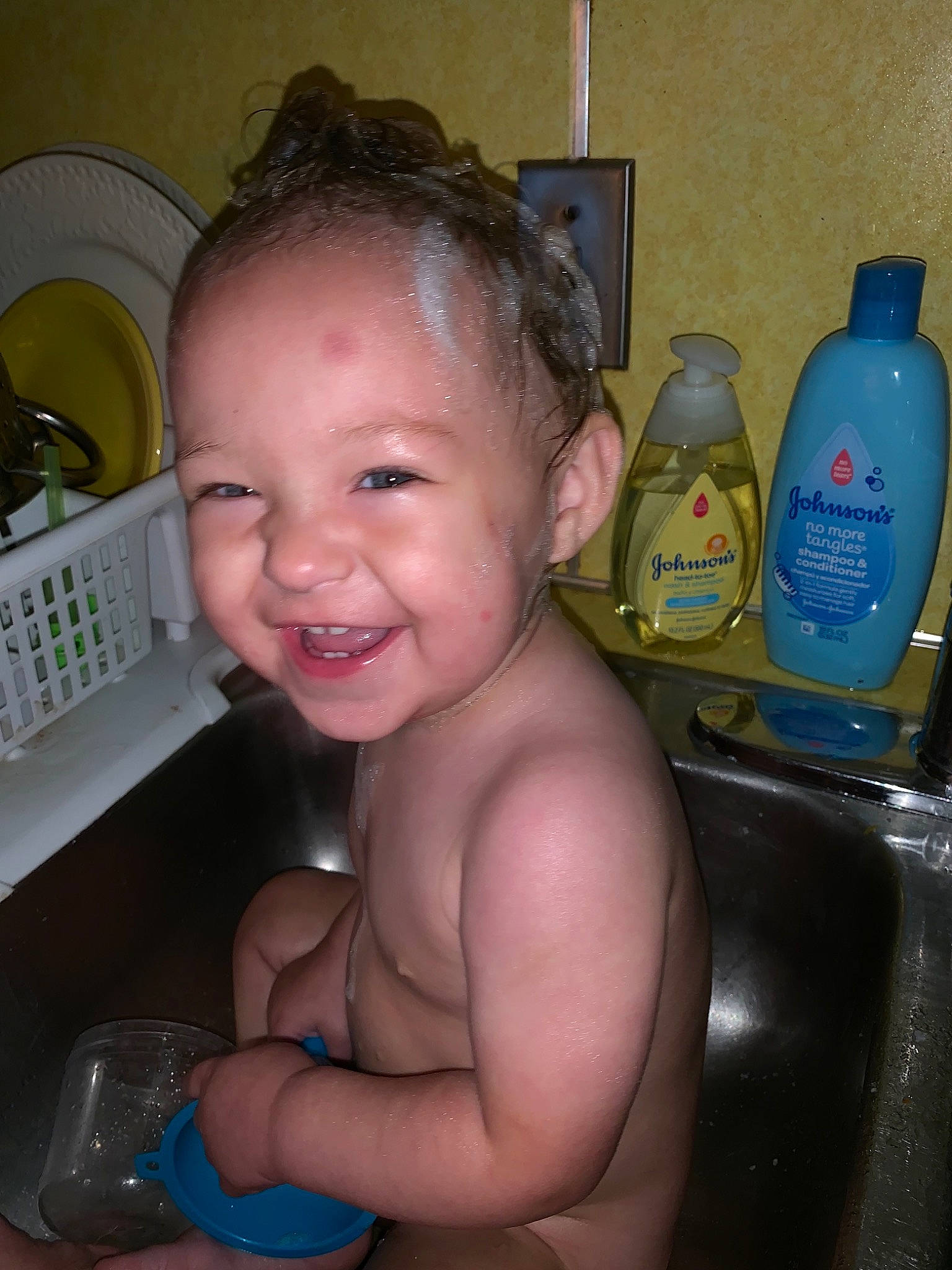 Sarah is registered to the contest to win money with this photo: baby, baby_bathing, bathing, cheek, chest, child, ear, eye, face, forehead, iris, joy, nose, person, plastic_bottle, product, skin, smile, toddler, washing