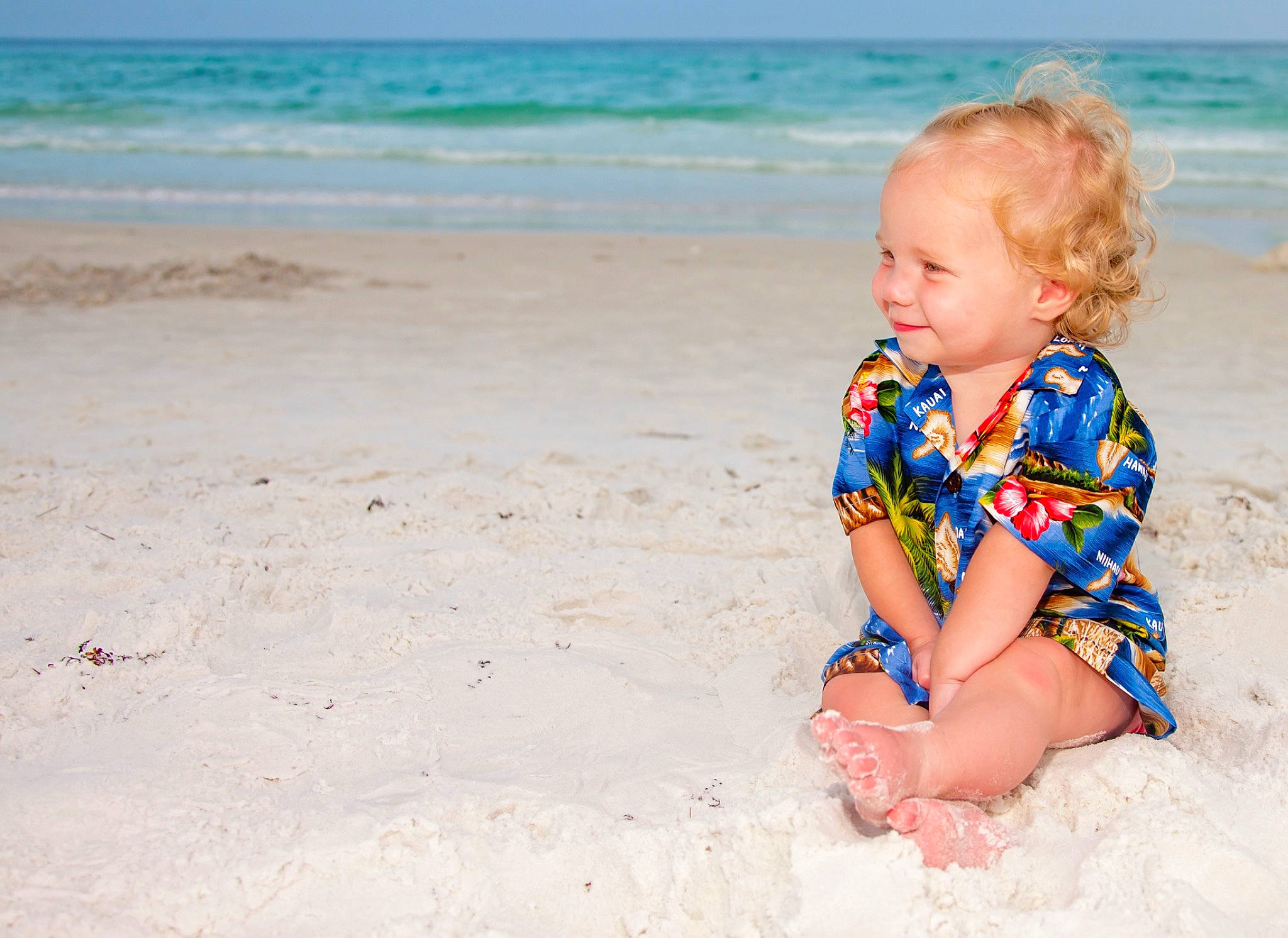 Emma is registered to the contest to win money with this photo: aqua, azure, baby, baby_toddler_clothing, beach, body_of_water, clothing, dress, eye, fun, grass, happy, leisure, people_in_nature, people_on_beach, person, sky, summer, toddler, travel