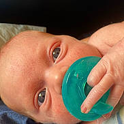 Austin is registered to the contest to win money with this photo: baby, infant, pacifier, hand, face, skin, eyes, close_up, blue_fabric, newborn, child, cute, resting, soft, portrait, young, human, childhood, peaceful, tender