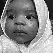 Aziyah is registered to the contest to win money with this photo: baby, child, face, hooded_towel, close_up, black_and_white, portrait, soft_texture, curious_eyes, wrapped, innocence, calm, young_child, towel, expression, indoor, person, head, skin, warmth