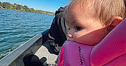 Alannah Carol joined the competition — help win amazing prizes! boat, child, clothing, face, hair_tied, lake, life_jacket, nature, outdoor, person, pink, portrait, recreation, reflection, sky, summer, sunlight, toddler, travel, water
