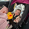 baby, car_seat, child, smiling, toy, rubber_duck, blanket, car_interior, seatbelt, child_safety, window, autumn, pink, clothing, head_support, happy, infant, portrait, cute, indoor