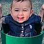 baby, child, swing, playground, smiling, tongue_out, navy_blue_clothing, green_swing, outdoor, daylight, earrings, short_hair, seat, happy, person, cute, fun, play, park, infant