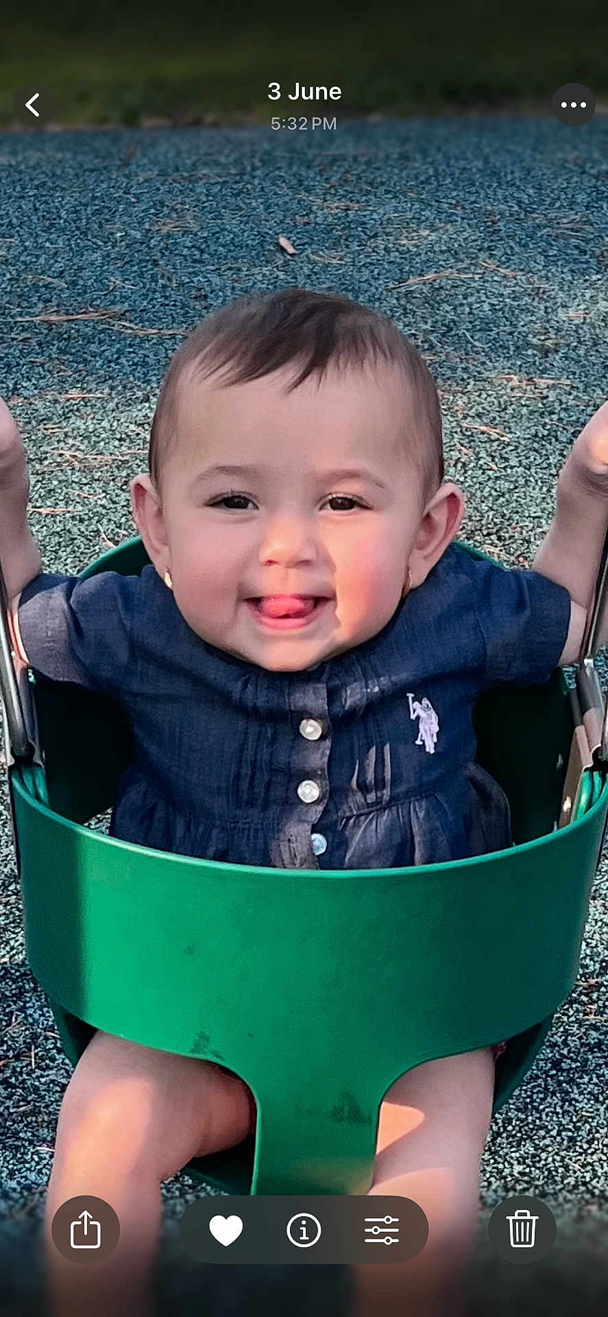 Ayla joined the competition — help win amazing prizes! baby, child, swing, playground, smiling, tongue_out, navy_blue_clothing, green_swing, outdoor, daylight, earrings, short_hair, seat, happy, person, cute, fun, play, park, infant
