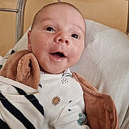 Charlie participe au concours pour gagner de l'argent avec cette photo : baby, bed, blanket, child, clothing, comfort, crib, cute, expression, fabric, face, happy, indoors, infant, newborn, person, portrait, smile, soft, warm