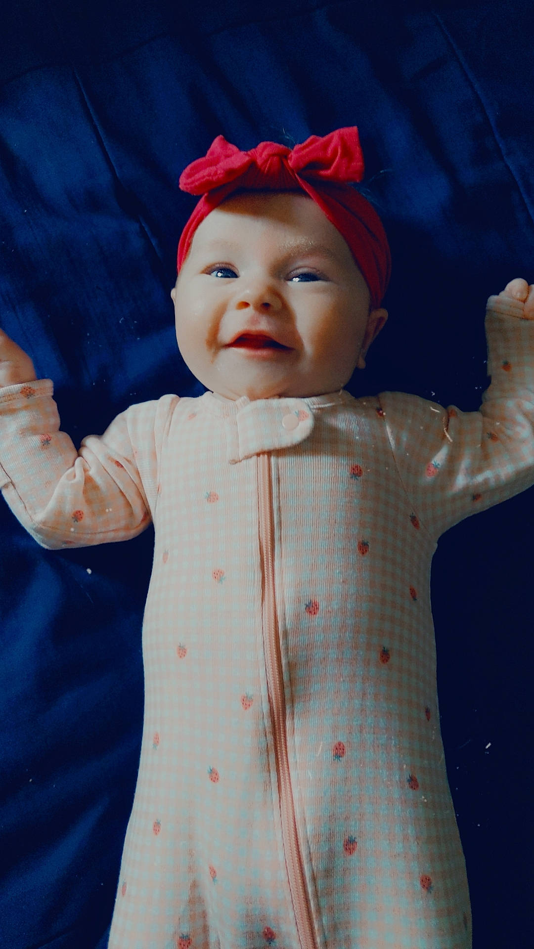 Eliza is registered to the contest to win money with this photo: arm, baby_toddler_clothing, cap, cool, eye, face, facial_expression, gesture, happy, head, headgear, headwear, human_body, organ, person, pink, skin, sleeve, smile, standing